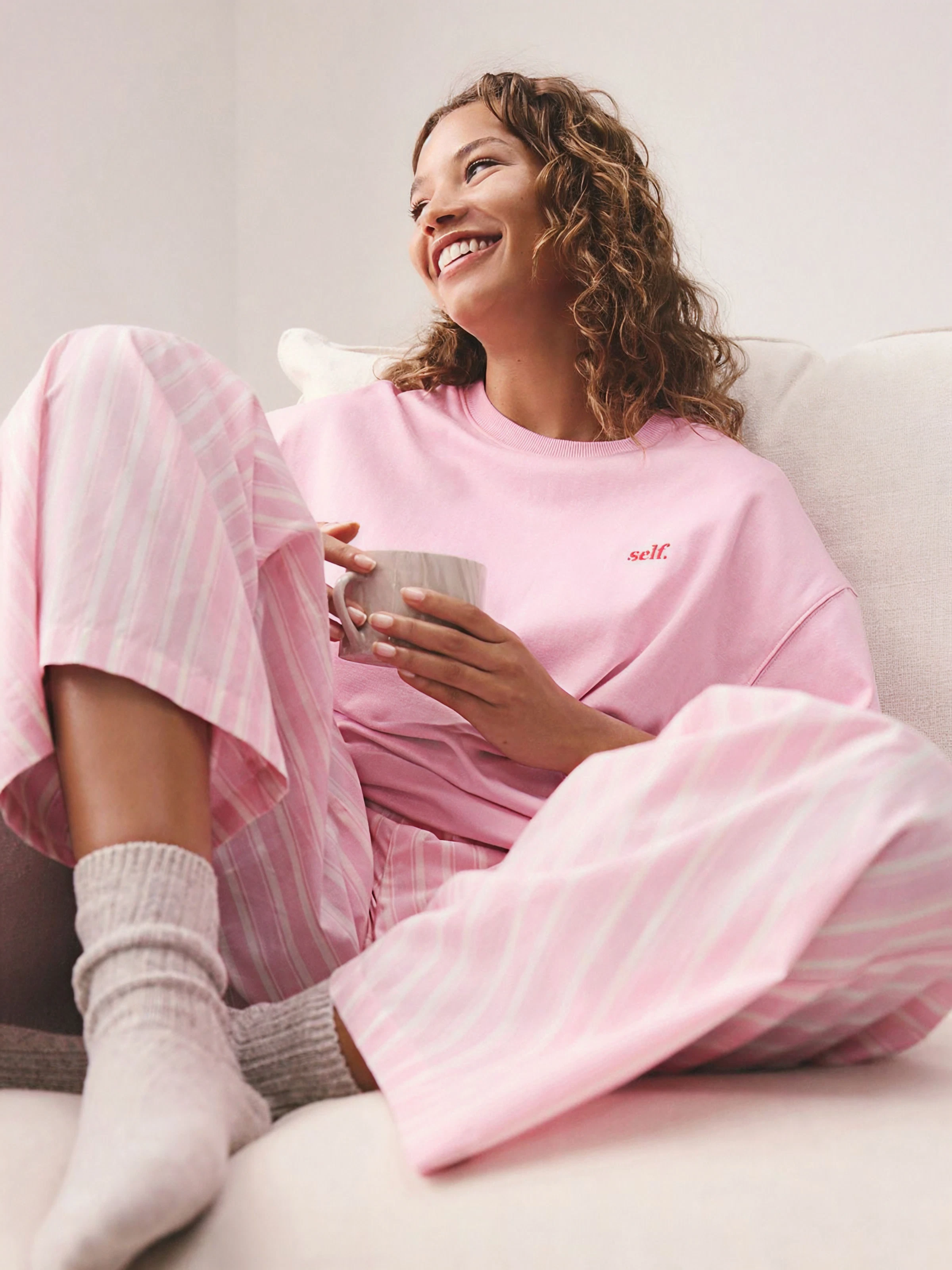 Woman wearing pink Dreamweave pajamas